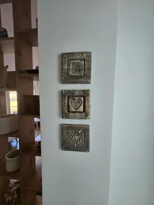 a refrigerator with four pictures on the side of it at Apartmani Krunet in Kruševac