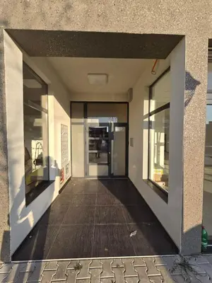 an empty hallway of a building with glass doors at Apartmani Krunet in Kruševac