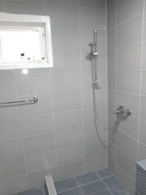 a bathroom with a shower with a glass door at Vila Tea Borsko Jezero in Bor
