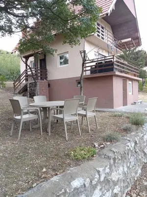 a table and chairs in front of a house at Vila Tea Borsko Jezero in Bor