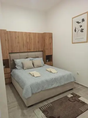 a bedroom with a bed with two napkins on it at Apartman Milutinovic in Vranje