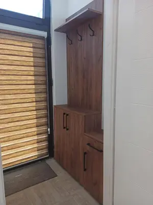 a closet with a wooden door and a window at Apartman Milutinovic in Vranje