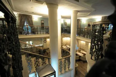 a view of a room with a staircase with columns at Luxury Rooms Minjon in Vrnjačka Banja