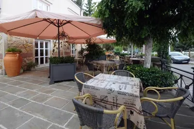 a table and chairs with an umbrella on a patio at Luxury Rooms Minjon in Vrnjačka Banja