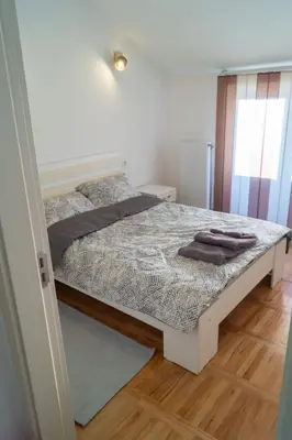 a bedroom with a bed in a room at Apartmani Stanković in Vranje