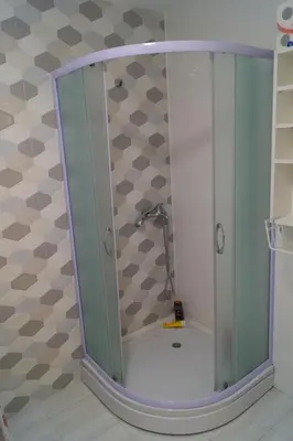 a shower with a glass door in a bathroom at Apartmani Stanković in Vranje