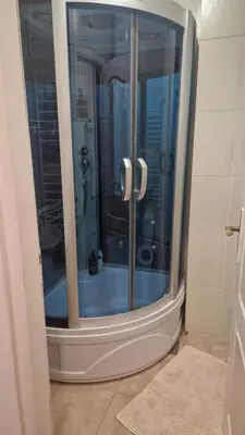 a shower with a glass door in a bathroom at JM Apartman in Donja Vrežina