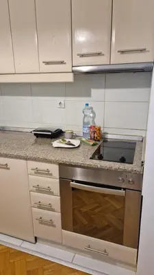 a kitchen with a sink and a stove top oven at JM Apartman in Donja Vrežina