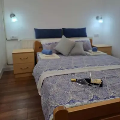 a bedroom with a bed with a gun on it at Vila Jevtic studio 4 in Soko Banja