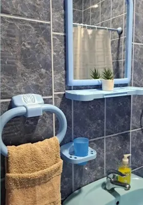 a bathroom with a sink and a mirror and a towel at Vila Jevtic studio 4 in Soko Banja