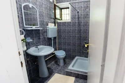 a bathroom with a sink and a toilet and a mirror at Vila Jevtic studio 4 in Soko Banja