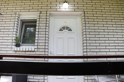 a white door on a brick building with a window at Vila Jevtic studio 4 in Soko Banja