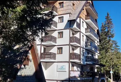 a tall building with balconies on the side of it at Vila Zvončica, apartman Puzović 21 in Kopaonik