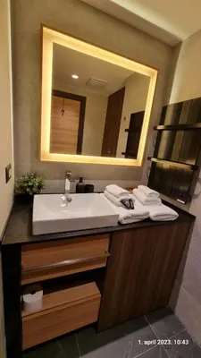 a bathroom with a sink and a mirror at Woodside Apartments Kopaonik centar in Kopaonik