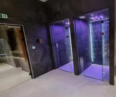 two elevators with purple glass doors in a building at Woodside Apartments Kopaonik centar in Kopaonik
