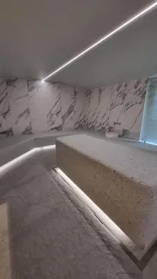 a room with a marble wall with a bench at Woodside Apartments Kopaonik centar in Kopaonik