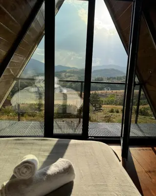 a room with a bed and a window with a view at Villa Monteverde Goč in Stanišinci