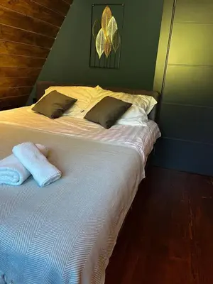 a bedroom with a bed with two towels on it at Villa Monteverde Goč in Stanišinci