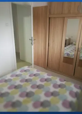 a bedroom with a bed and a cabinet with a mirror at Apartman Sokobanja in Soko Banja
