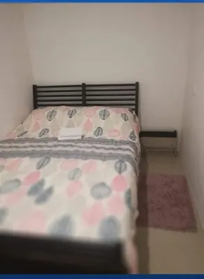 a bedroom with a bed with a book on it at Apartman Sokobanja in Soko Banja