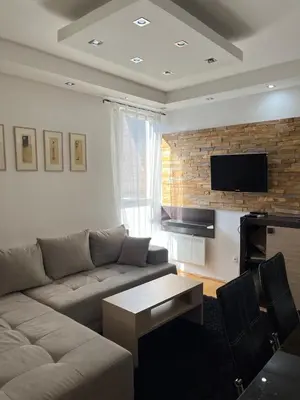 a living room with a couch and a flat screen tv at Apartmancic Stancic in Kopaonik