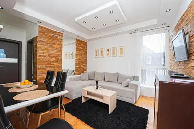 a living room with a couch and a table at Apartmancic Stancic in Kopaonik