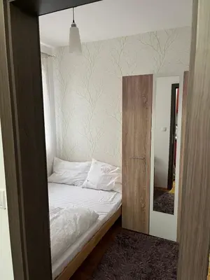 a small bed in a room with a mirror at Apartmancic Stancic in Kopaonik