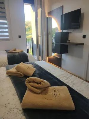 a hotel room with two towels on a bed at Apartman Novak Sokobanja in Soko Banja