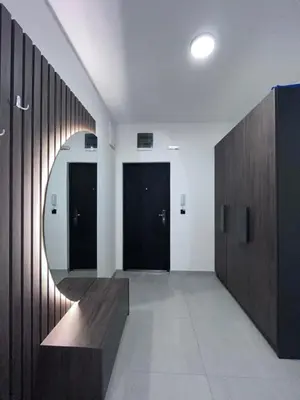 a hallway with a mirror and a wooden wall at Apartman Novak Sokobanja in Soko Banja