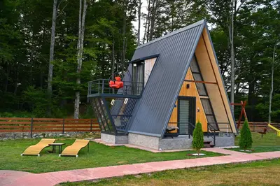 a tiny house with a man on a swing at Gočki Raj in Goč