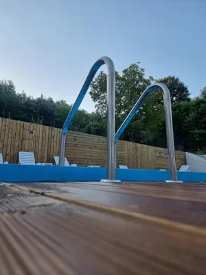 a jump in a swimming pool with two metal bars at Apartman Nika Vb in Vrnjačka Banja