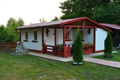 a small house with a red and white at Gocki raj 2 in Goč