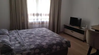 a bedroom with a bed and a flat screen tv at Alđo in Soko Banja