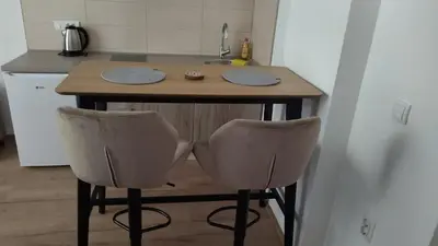 a kitchen with a small island with two bar stools at Alđo in Soko Banja
