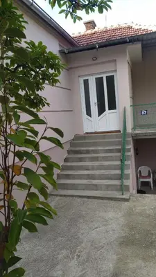 a house with stairs and a white door at Alđo in Soko Banja