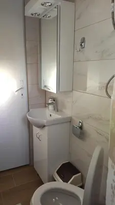 a bathroom with a sink and a toilet and a mirror at Alđo in Soko Banja