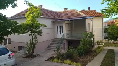 a house with a staircase in front of it at Alđo in Soko Banja