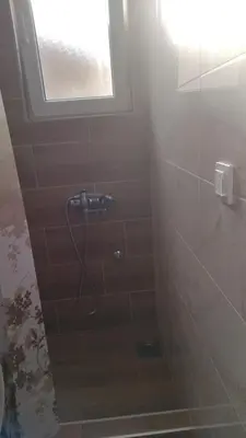 a bathroom with a shower with a window at Alđo in Soko Banja