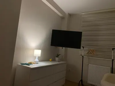 a living room with a tv on a wall at Urban Apartman-privatan parking- in Kraljevo