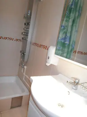 a bathroom with a toilet and a sink and a mirror at HOTEL Crystal Lights in Pirot