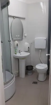 a bathroom with a toilet and a sink and a shower at HOTEL Crystal Lights in Pirot