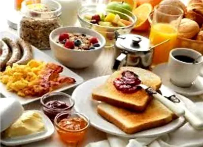 a table topped with plates of breakfast foods and drinks at HOTEL Crystal Lights in Pirot