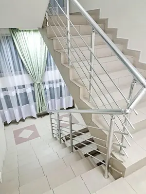 a metal staircase in a house with white walls at HOTEL Crystal Lights in Pirot