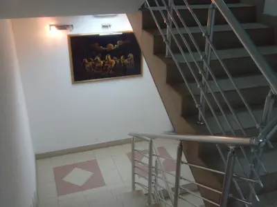 a staircase with a painting on the wall and a stair case at HOTEL Crystal Lights in Pirot