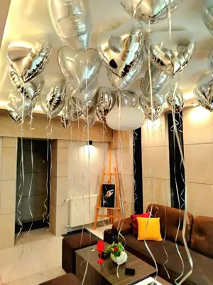 a room with a bunch of silver balloons hanging from a ceiling at Art Lux apartman in Kruševac