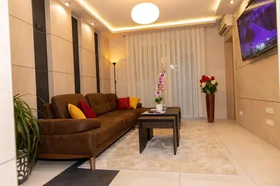 a living room with a couch and a table at Art Lux apartman in Kruševac