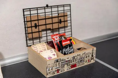 a box filled with books sitting on the floor at Art Lux apartman in Kruševac