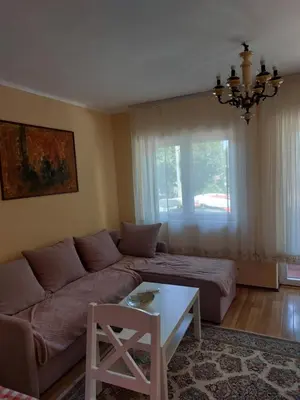 a living room with a couch and a table at Dukat 1 in Soko Banja
