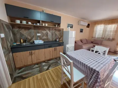 a kitchen with a sink and a table in a kitchen at Dukat 1 in Soko Banja