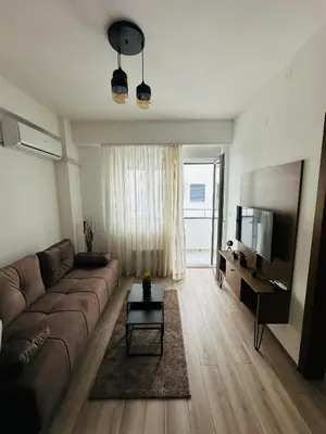 a living room with a couch and a flat screen tv at Aqua apartman 45-2 in Jagodina